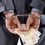 bigstock-Man-handcuffed-for-his-crimes-29615276-W300