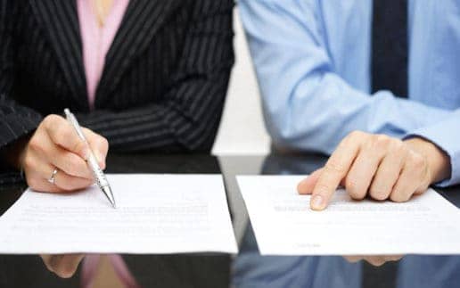 businessman and businesswoman are inspecting contract in suit