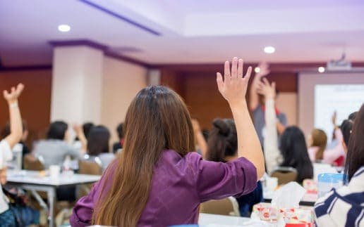 Business People Raise Their Hands To Vote For Shareholders’ Meet