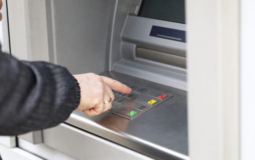 Man Dials Pin Code To Withdraw Money From Atm. Man Stands Nea Te