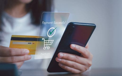 Female Holding Credit Card And Using Mobile Smart Phone For Onli