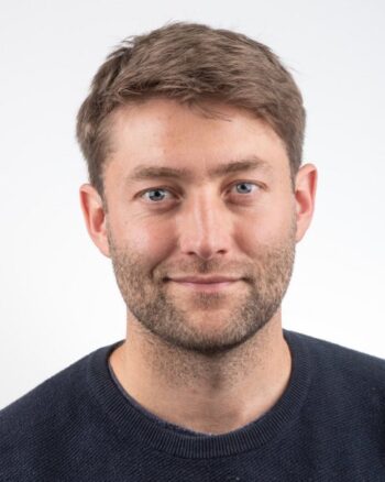 Malte Unger, Managing Director von adesso ventures, präsentiert sich mit einem neutralen Ausdruck. Der Hintergrund ist schlicht und hell, was die Aufmerksamkeit auf seine Person lenkt. Die Aufnahme vermittelt Professionalität und Kompetenz im Bereich FinTech und Compliance.